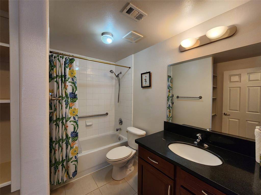 Hall bath just outside the 2nd bedroom, with tub/shower, linen cabinet.