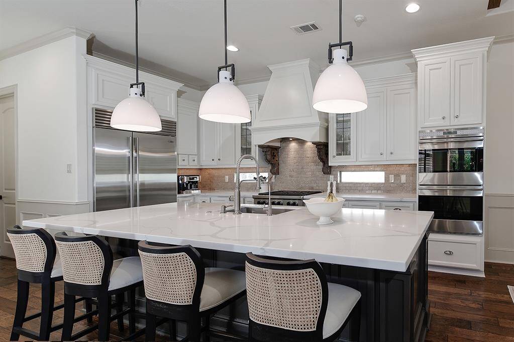 Gourmet kitchen with an expansive island, premium appliances and beautiful Quartz countertops