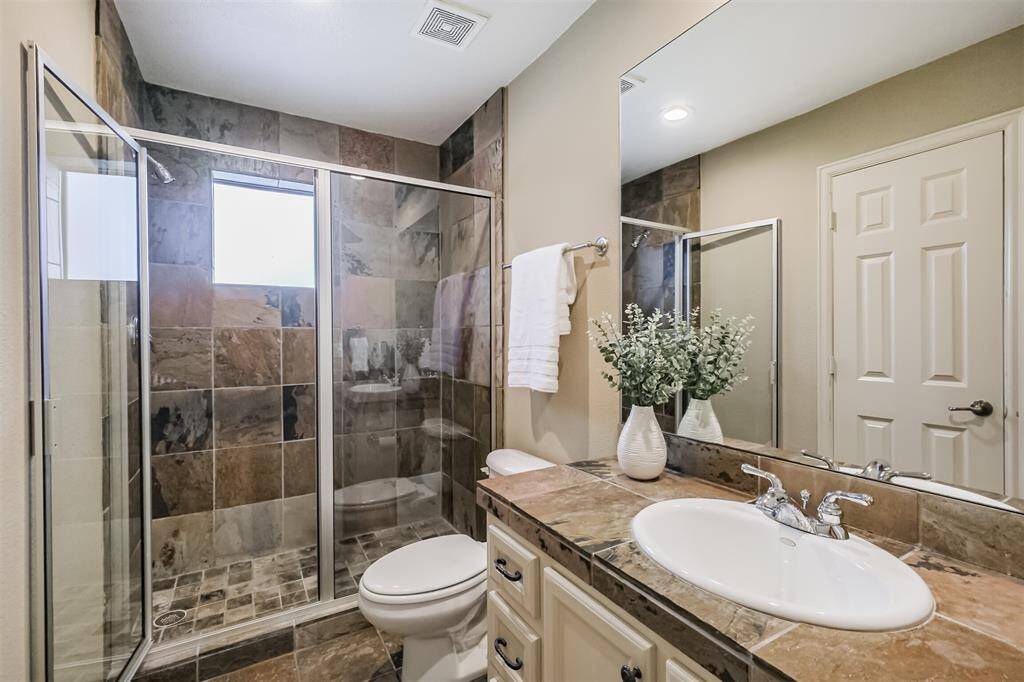 This bathroom is off bedroom 3 - featuring a stand-alone shower and attached closet.