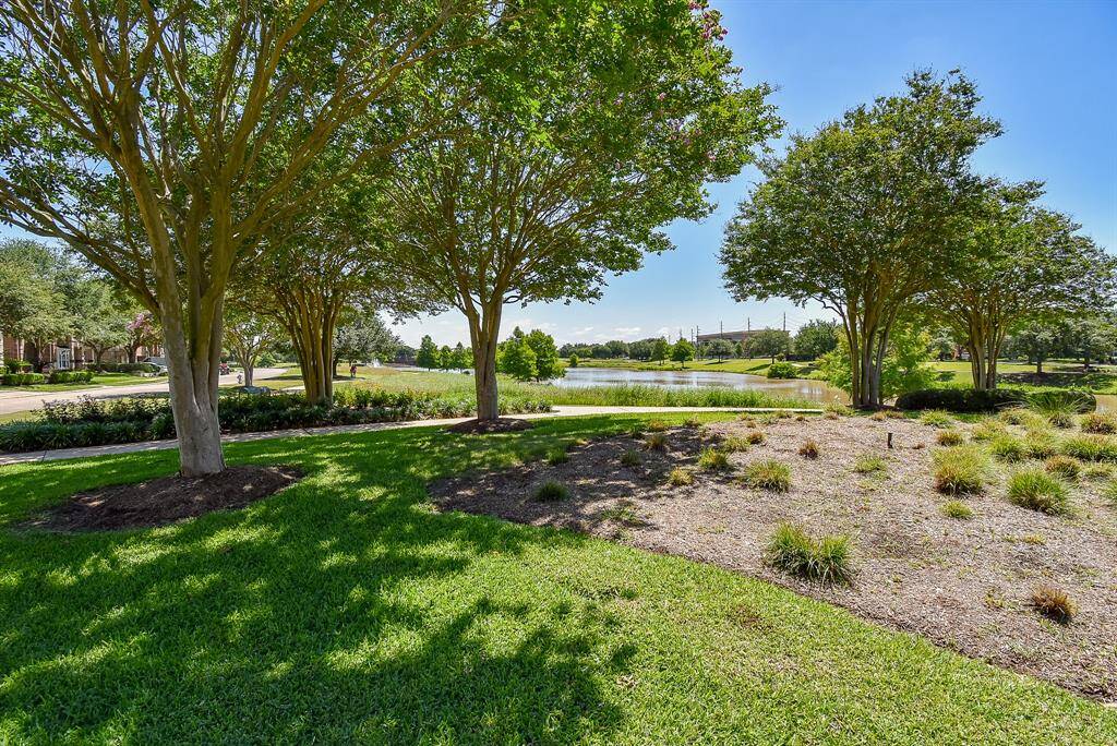 From the front yard, a glimpse of the waterfront adds to the property’s tranquil appeal.
