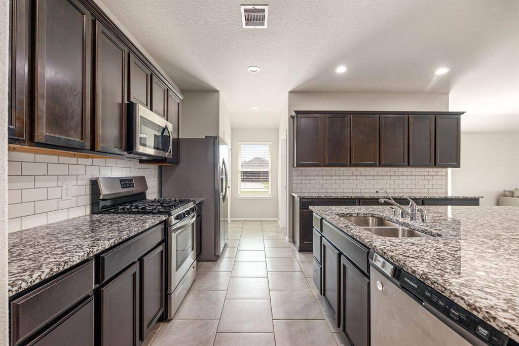 Any chef's dream, this stunning kitchen is perfect for everyday life as well as entertaining family and friends! Extra large kitchen island is perfect for conversation or that much needed space to lay out your party spread for everyone to enjoy! Large windows provide lovely views of your yard and plenty of natural lighting throughout the day.