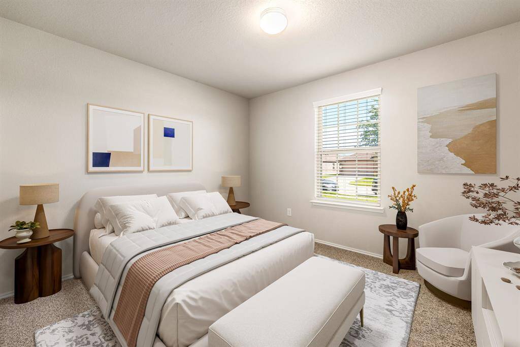 Secondary bedroom features plush carpet, neutral paint, overhead lighting and a large window with privacy blinds. *virtual staging*