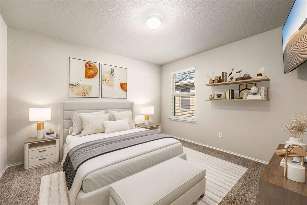 Secondary bedroom features plush carpet, neutral paint, overhead lighting and a large window with privacy blinds. *virtual staging*