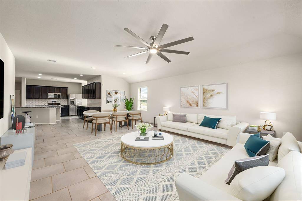 This light and bright spacious living room is the perfect layout for entertaining or just relaxing. Whether it's simply a night in or entertaining family and friends, this home has ample open space for everyone to enjoy! Featuring ceiling fans, large tile flooring, large windows with blinds, recessed lighting with wonderful access to your gorgeous kitchen. *virtual staging*