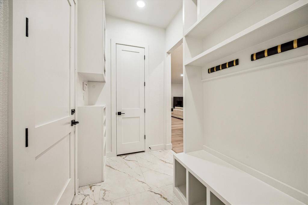 Mudroom adjacent to kitchen with access to the pantry.