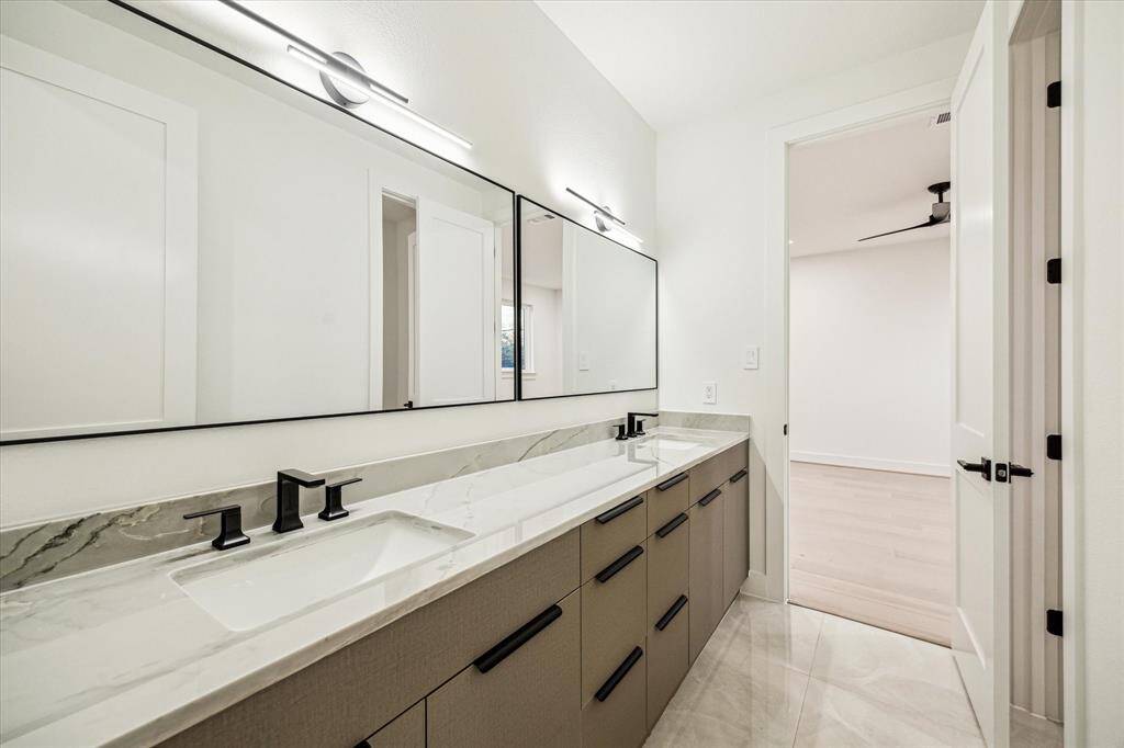 Guest bathroom with door separating vanity from shower area.