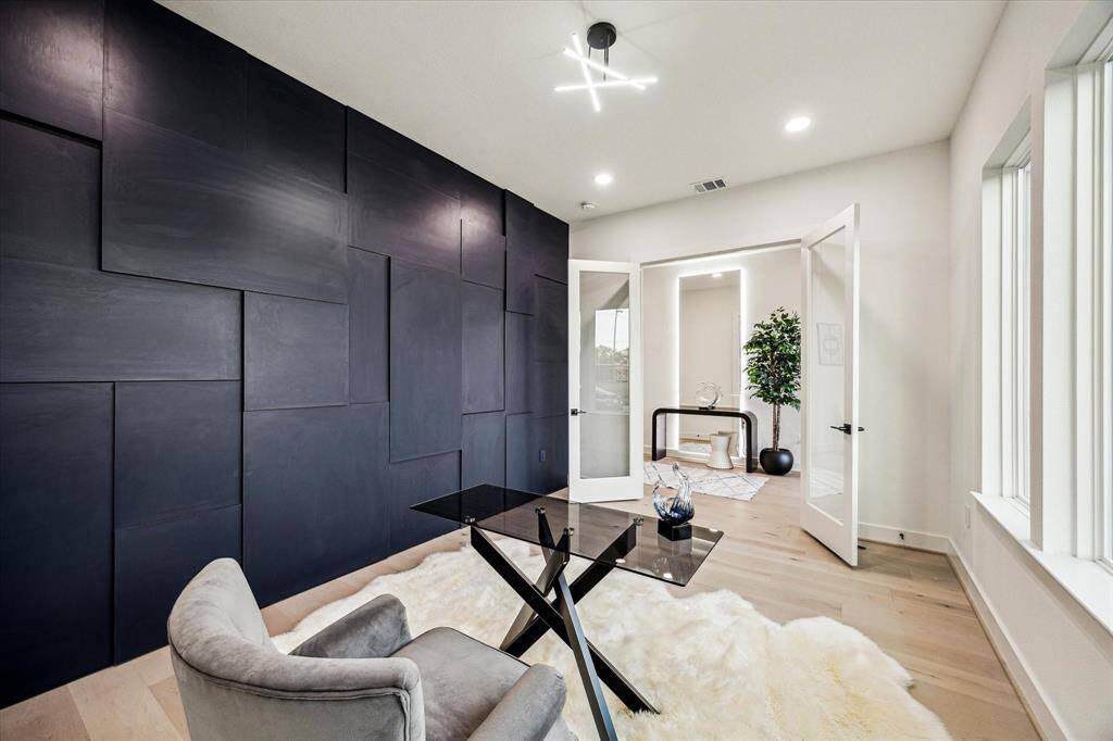 Office with custom geometric accent wall.