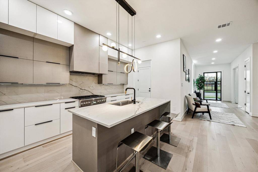 Cabinets featuring bottom drawers and wall-mounted lift upper cabinets.