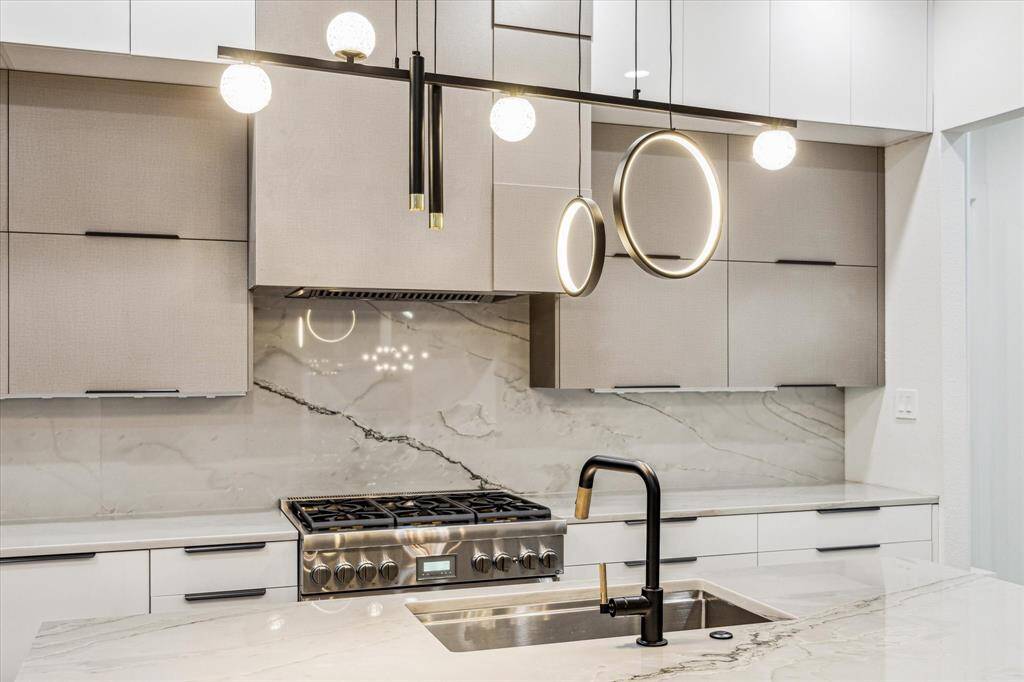 Closer view of the geometric hood design, complementing the modern Brizo faucet.