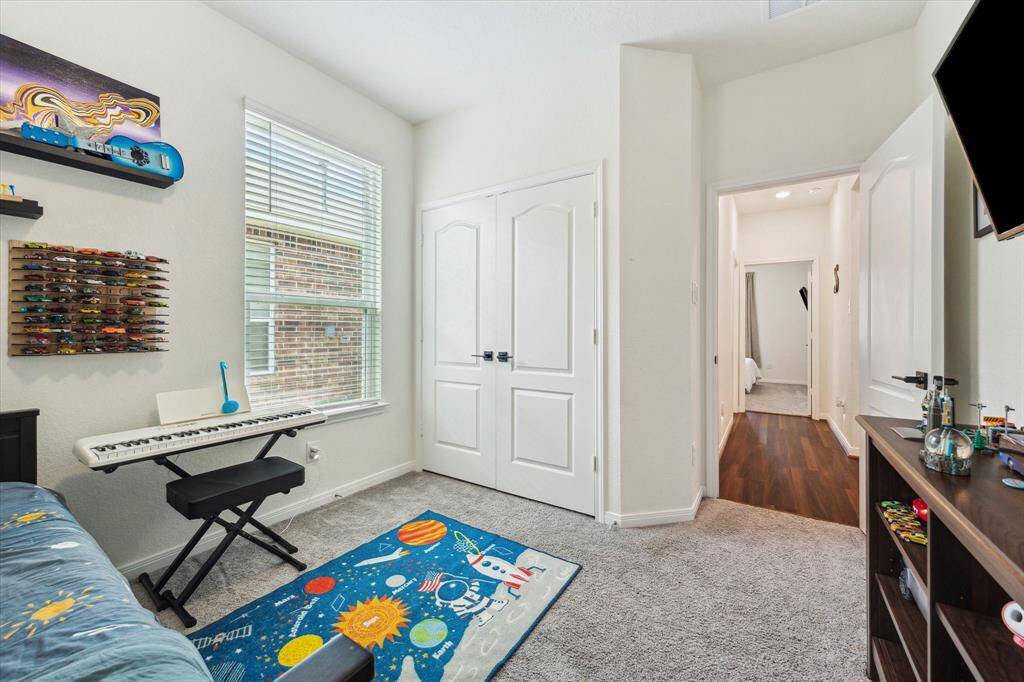 One of two secondary bedrooms, with double-wide closets.