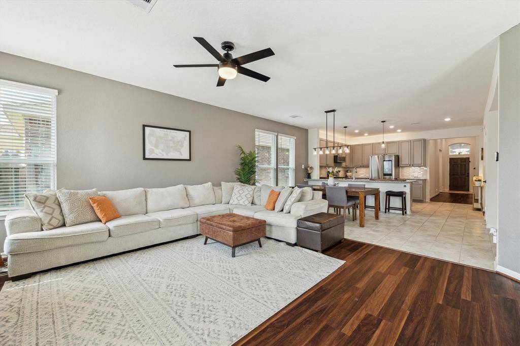 The entryway is upgraded with high-ceilings, creating an airy entrance that leads to the open-yet-defined kitchen, dining and family room spaces.