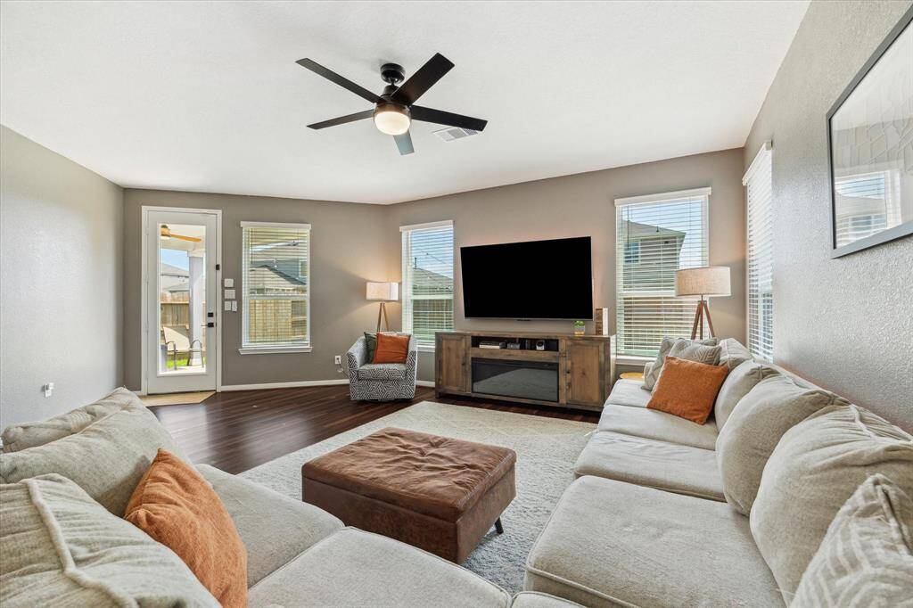 The family room is filled with natural light and looks out into the backyard.