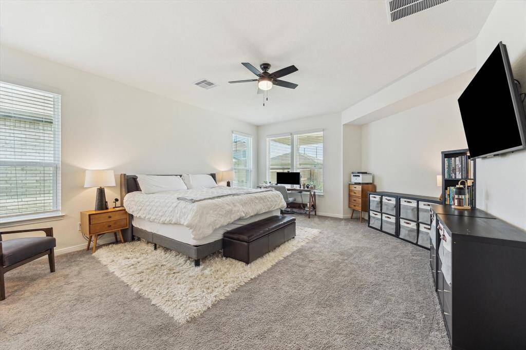 The primary suite is tucked away off of the kitchen, dining and family room for a suite retreat.