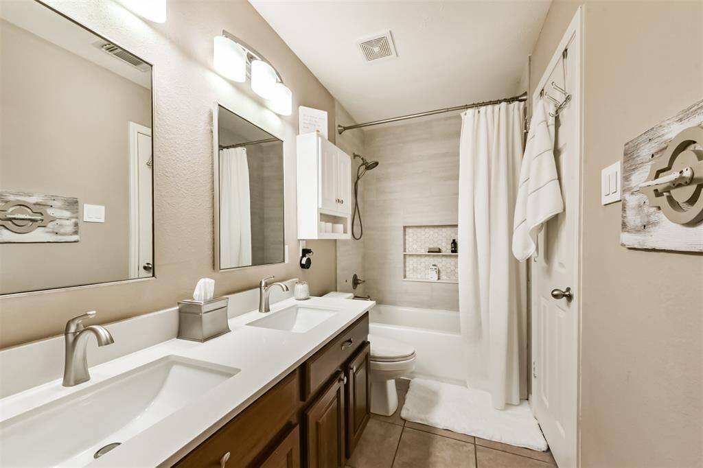 Secondary remodeled bathroom with plenty of storage.