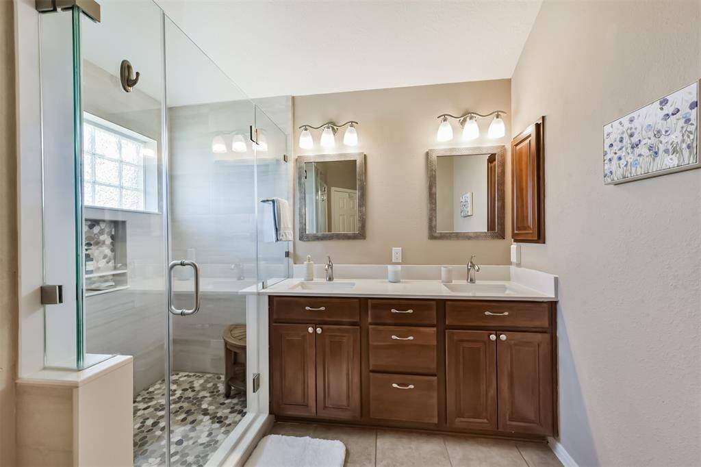 Remodeled master bathroom with large shower and plenty of cabinet space.