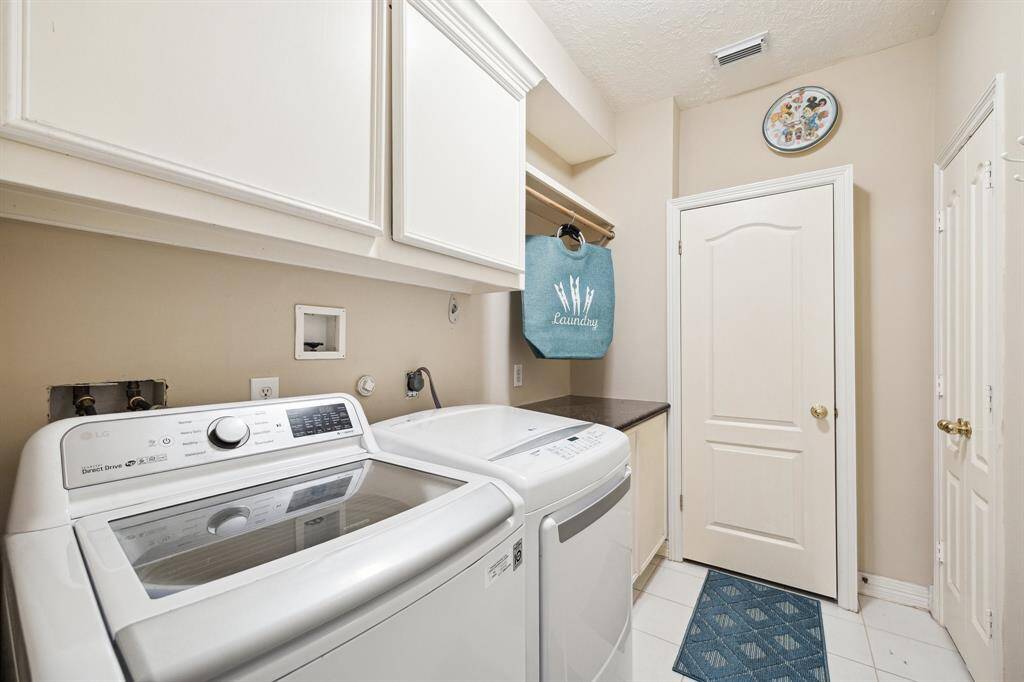 Laundry room with a laundry chute that collects from upstairs