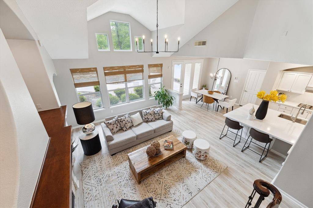 This is the view of the open floor plan this home has , showing the flooring, the quartz countertops, freshly painted.