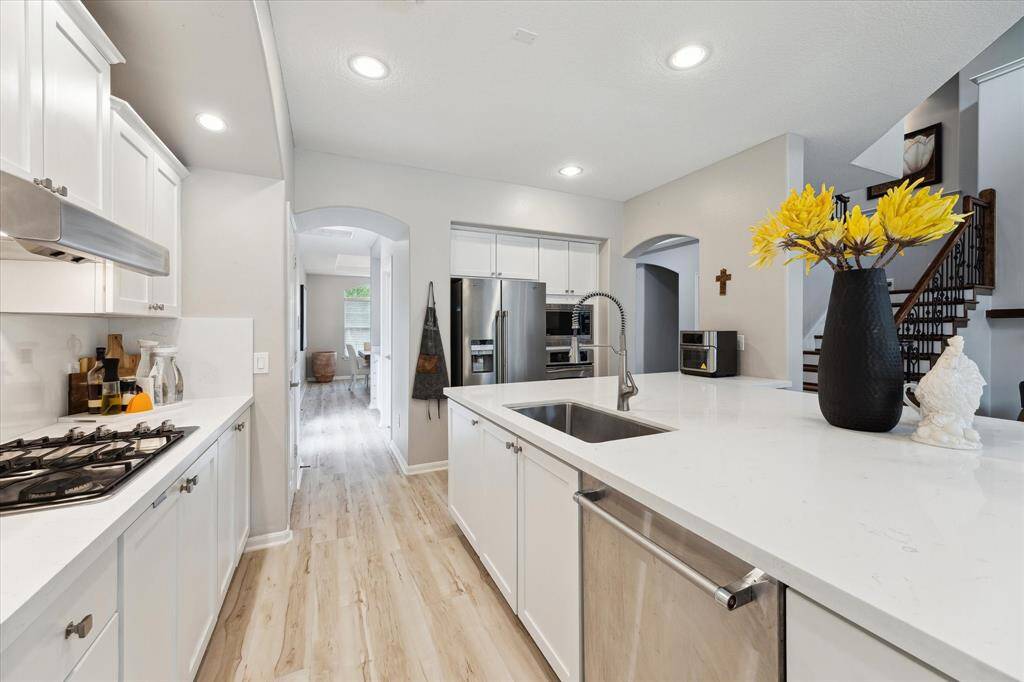 This is the view from the breakfast area to the kitchen, the coffee station or butler's pantry, laundry and also a secondary exterior door to the porte-cochere
