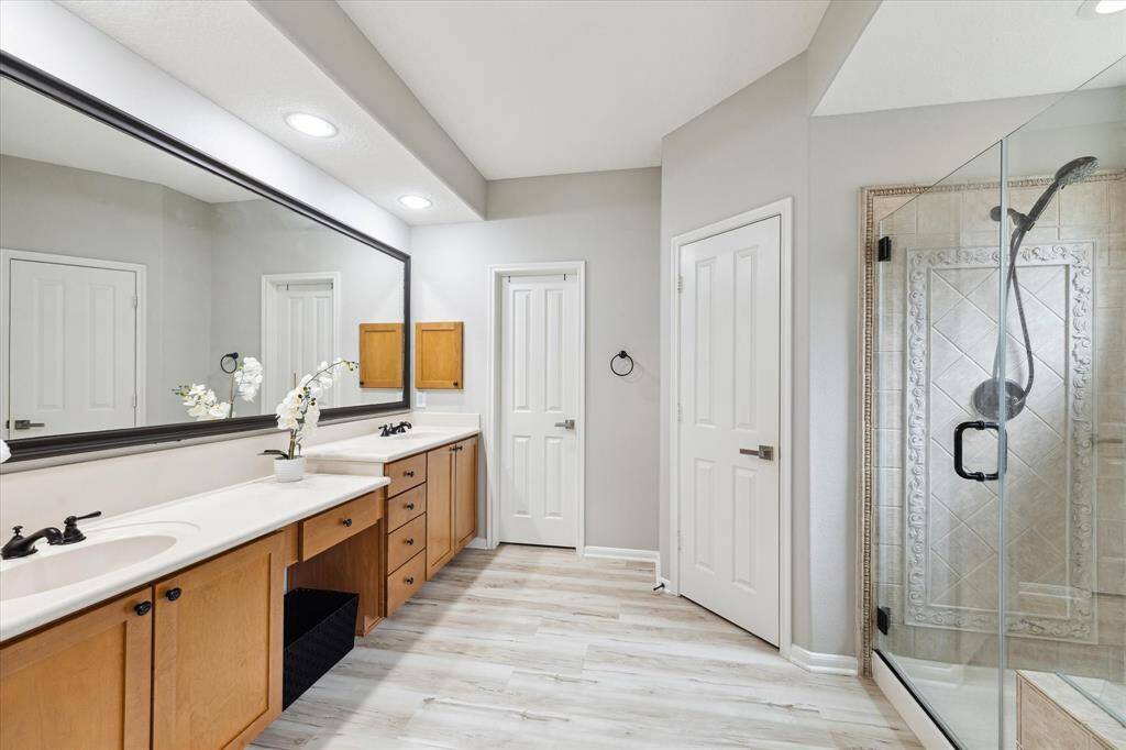 The master bathroom with two sinks,  waking shower and tub, a great size closet