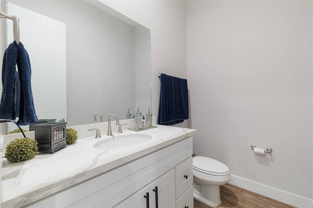 Half bath located off the kitchen.