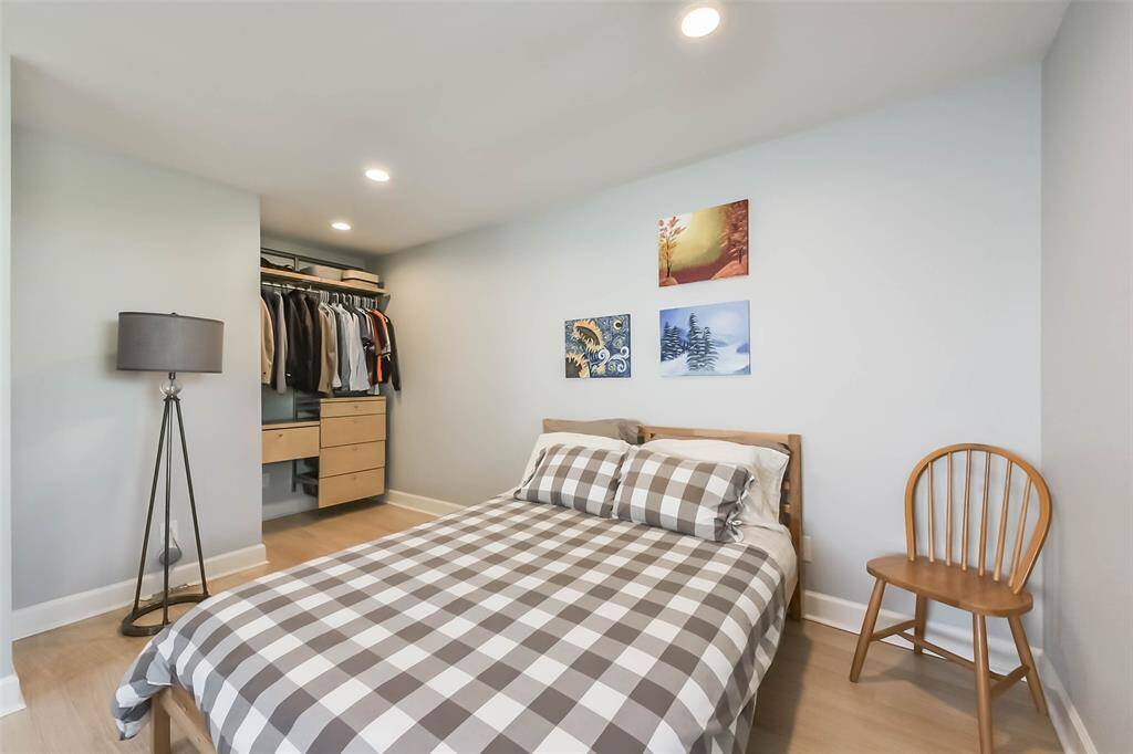 The sleeping area features an open wardrobe which contributes to the lofty ambiance of the room.