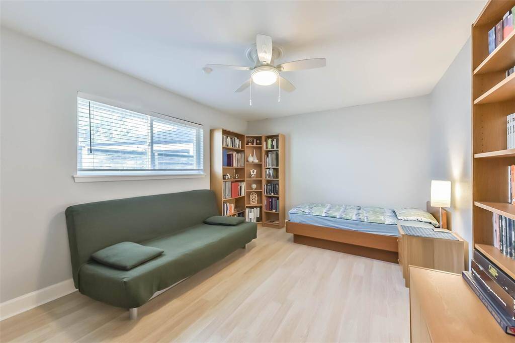 This secondary bedroom is equally generously sized and offers space for a desk, a small library, and a sitting area.