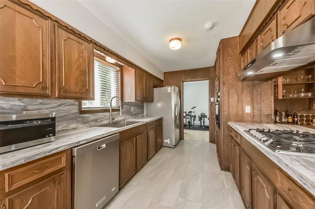 The kitchen is well equipped with an oversized gas stove, electric oven, dishwasher, large refrigerator/freezer, microwave, and a modern sink. Your groceries can be conveniently stored in the ample pantry.