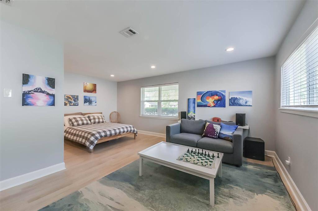 This spacious secondary bedroom could easily serve as another primary. The queen size bed is cozily tucked away in a niche separating it from the sitting area.