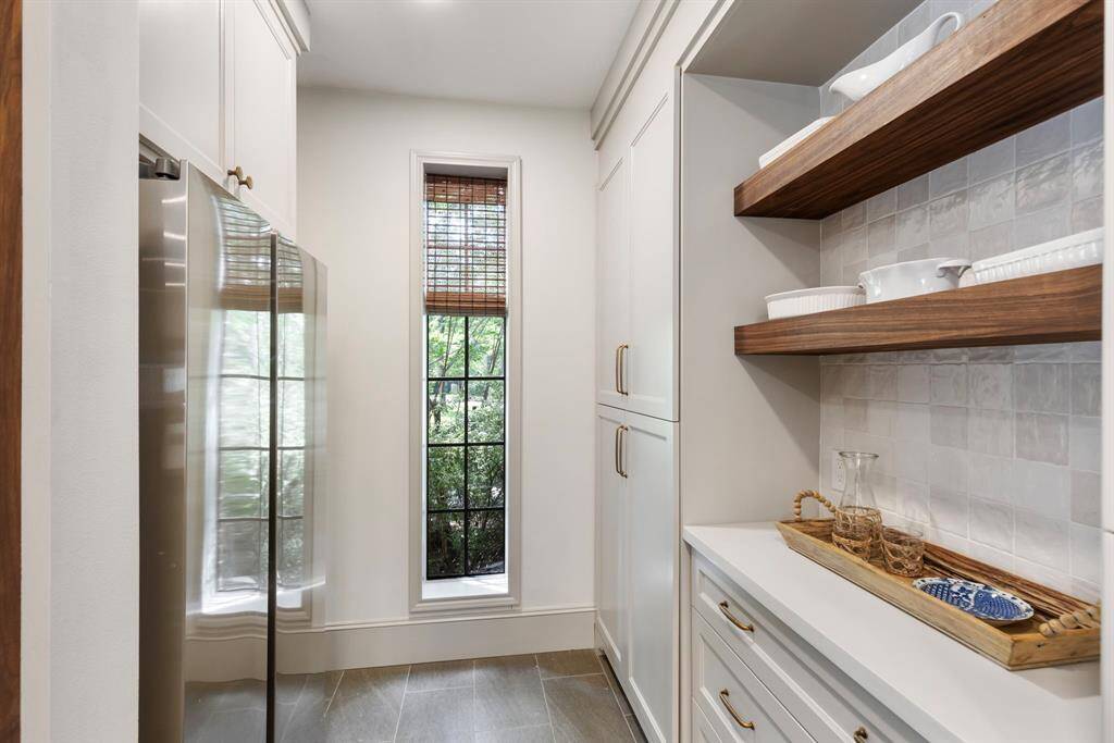 Butlers pantry with second refrigerator. Hidden microwave and extra counter space not picured.