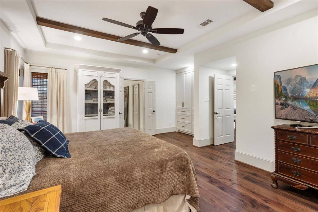 Primary suite with built in armoire. Under stair storage currently used for suitcase storage.