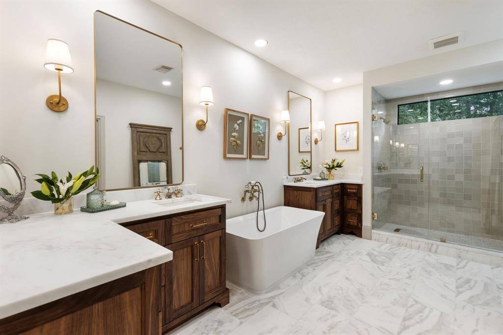 Newly redesigned shower and soaking tub. Custom Black walnut cabinetry with natural marble counter tops