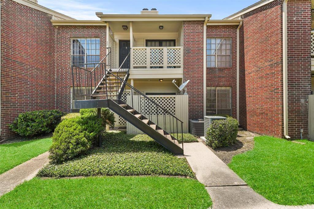 Welcome home to this charming ground-level condo with private covered entrance and lush green landscaping!
