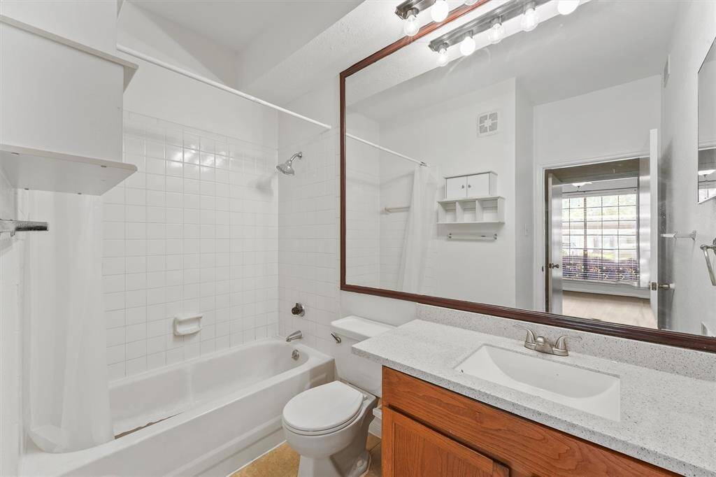 Convenient second bathroom with classic tile and practical storage, ready for your personal touch.