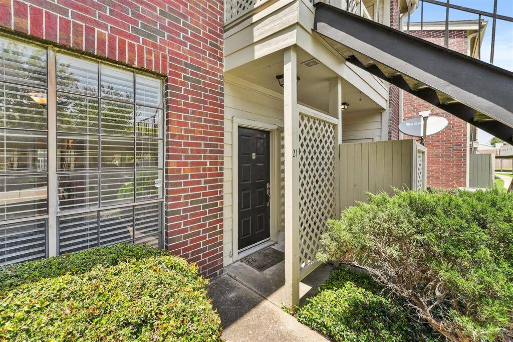 Enjoy added privacy and security with a covered entryway tucked behind a charming lattice fence.
