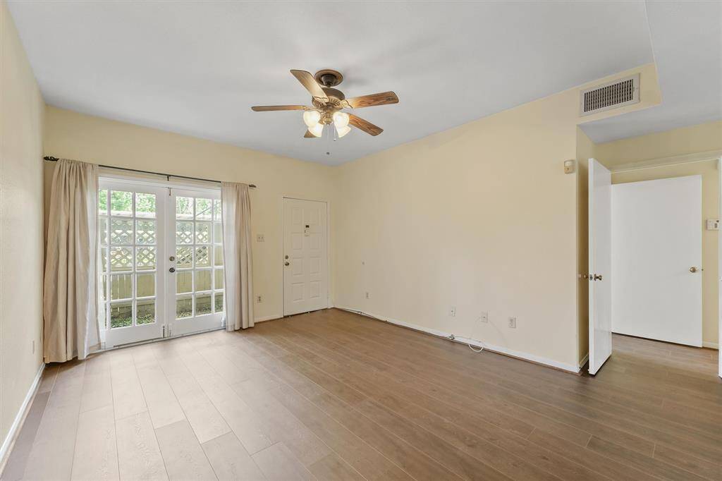 Light-filled living room with French doors opening up to your private patio oasis.