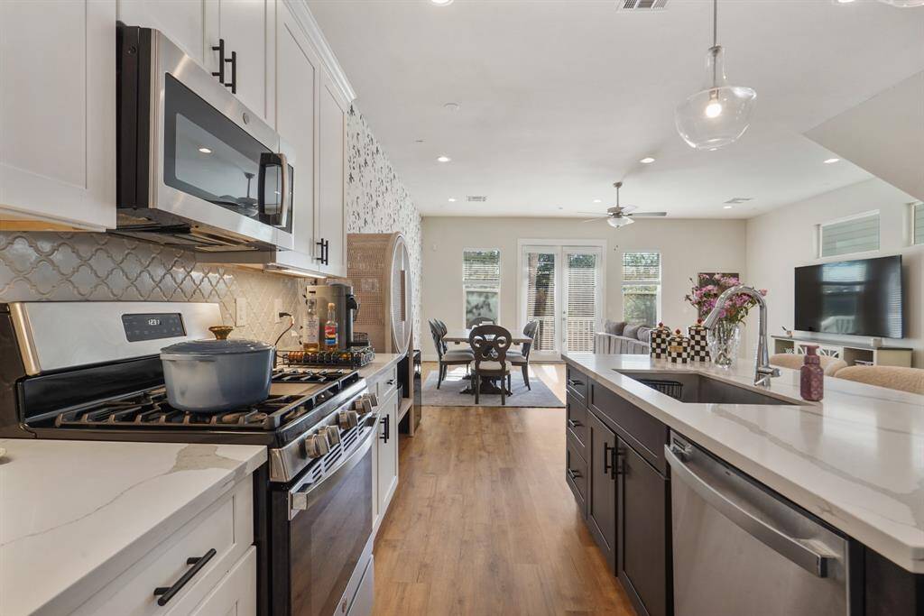 Beautiful backsplash, cabinets and modern appliances