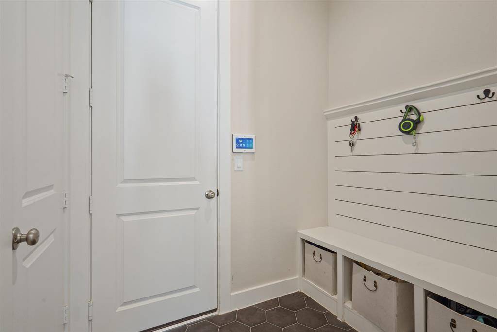 Large mudroom off of the garage/kitchen with half bath