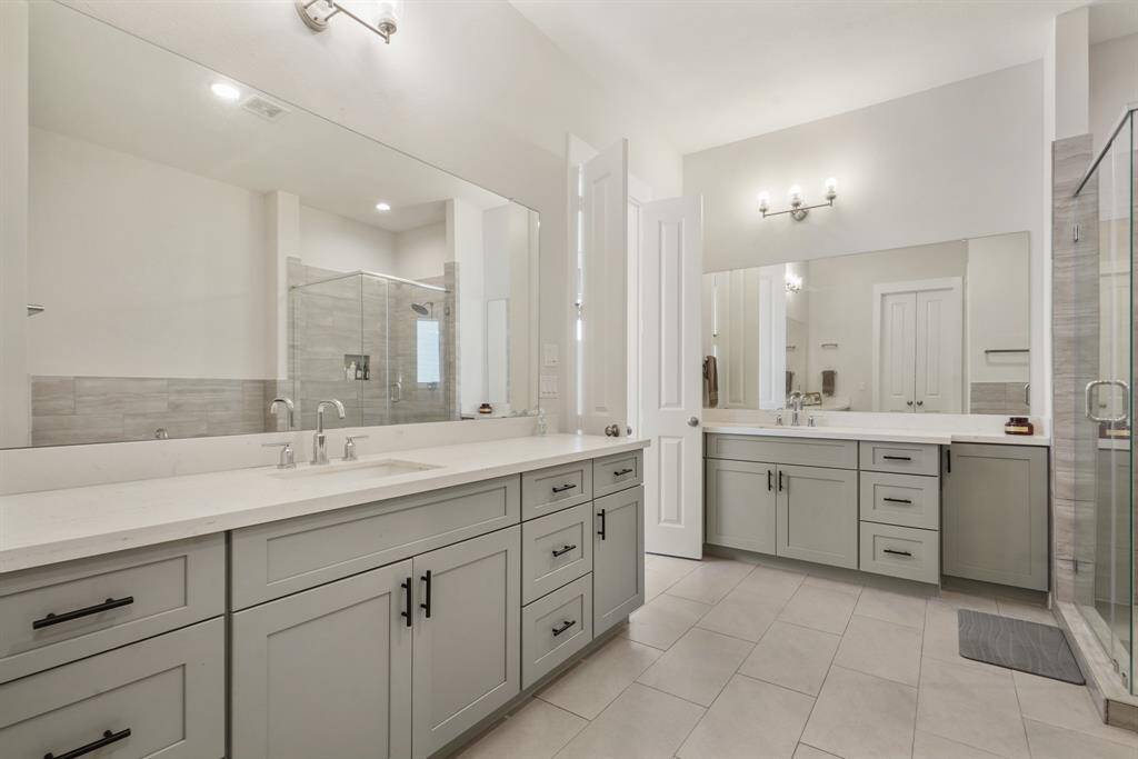 Gray shakers with modern hardware and oversized flooring tiles