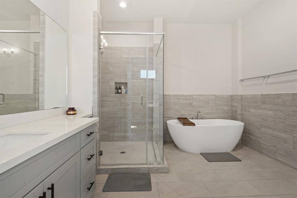View of large seamless shower and soaking tub