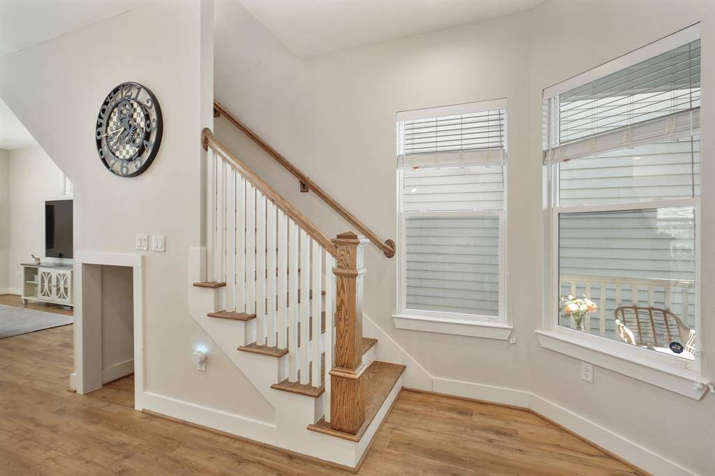 View of the stairs off of the front door and cute built-in Dog House