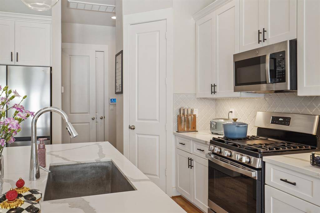 Prep space with white shaker cabinets and modern hardware