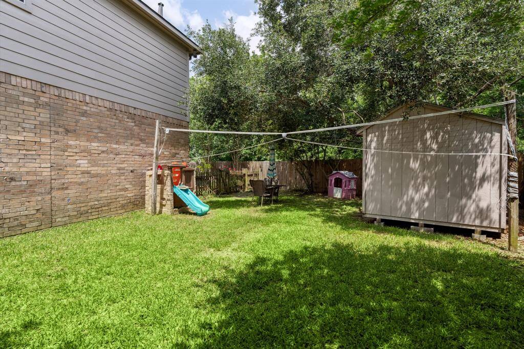 The backyard also has a storage shed.