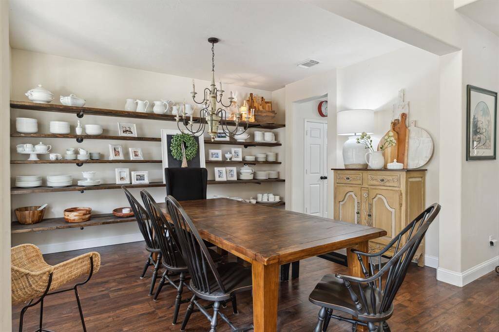 This breakfast room is bathed in naturallight streaming through expansivewindows.