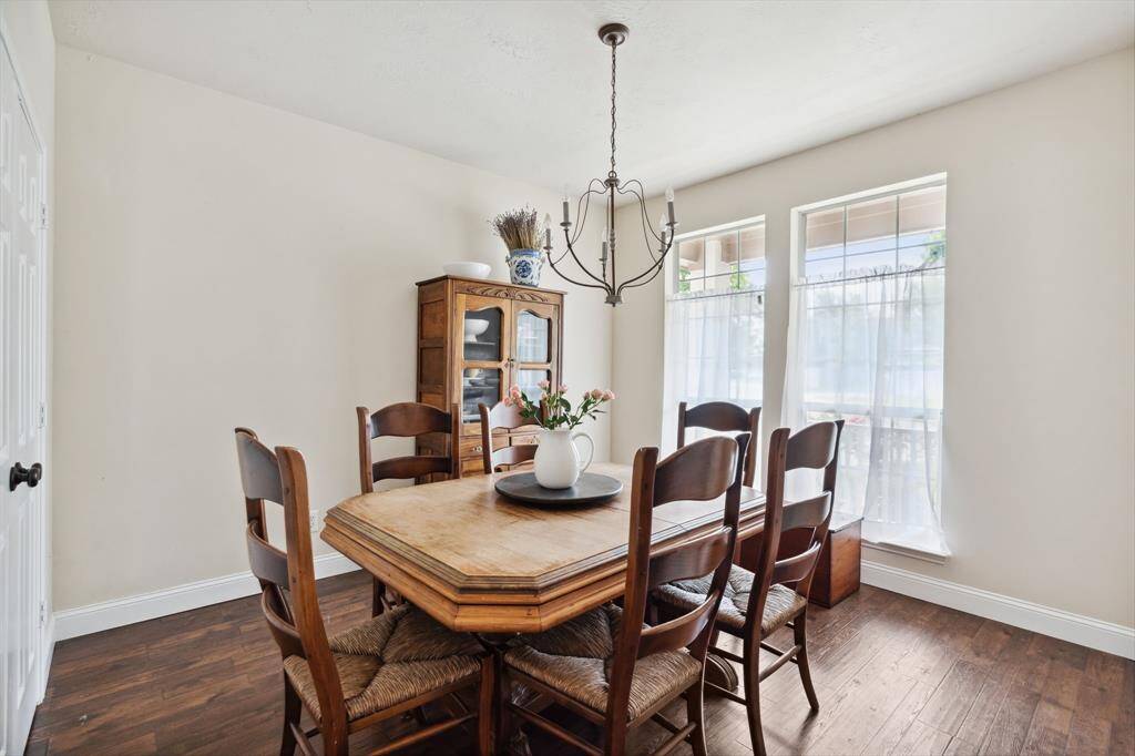 The dining room could also be used as a home office with french doors, large windows, and a chandelier.