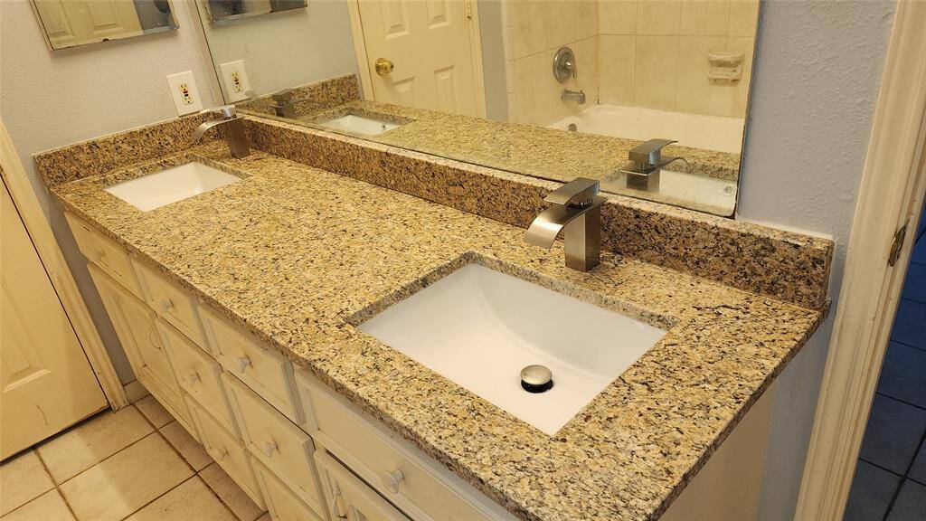 Mater bath with tile, double sinks, granite counter top and shower tub