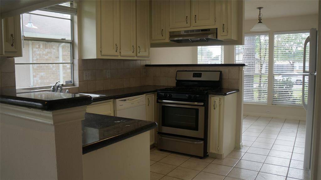 Granite counter kitchen leading to breakfast area