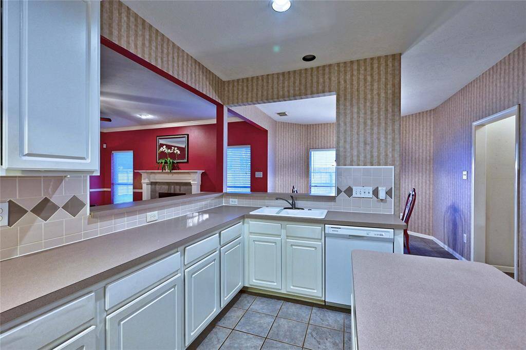 An open layout connects to a living area and breakfast room.