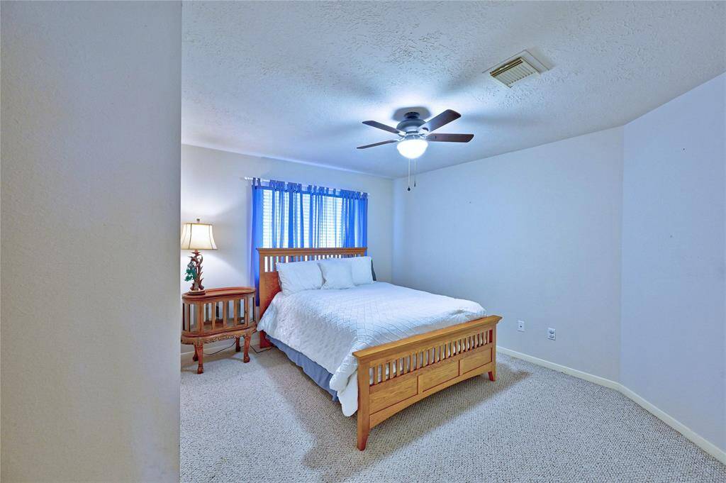 Bedroom 3 features neutral walls, carpeted flooring, and a ceiling fan.