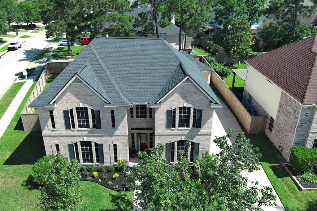 Recent Roof with radiant Barrier.  The house features a prominent entrance, multiple windows, and is situated in a suburban neighborhood.