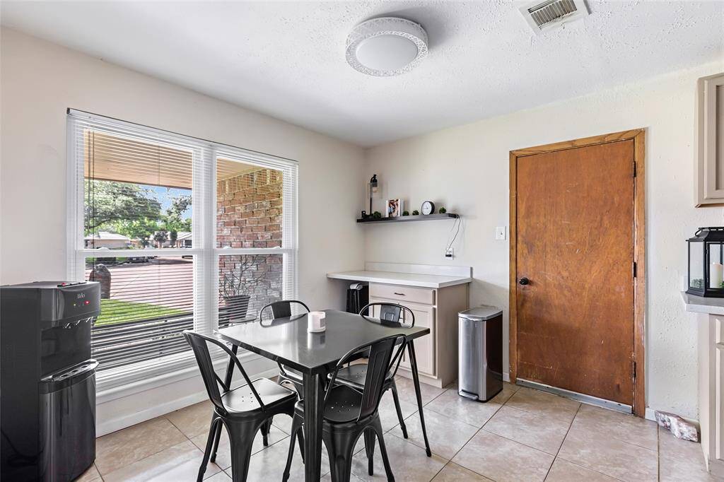 Dining space leads to garage and has access to back patio and laundry.